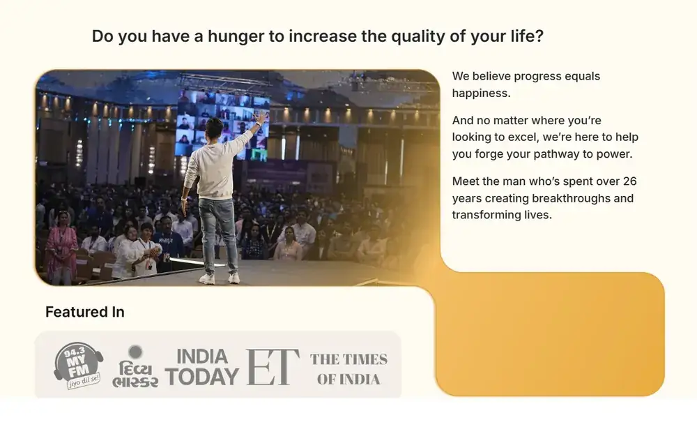 Sneh Desai on stage addressing a large live seminar audience